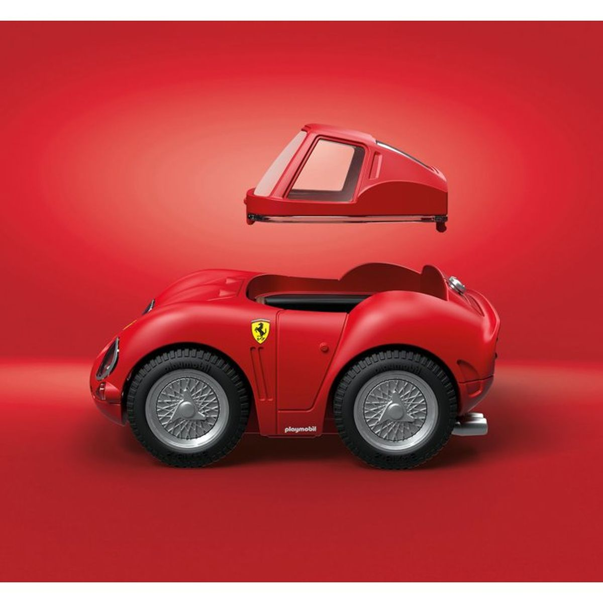 Çıkarılabilir tavanlı kırmızı oyuncak yarış arabası. Yanında Ferrari logosu.