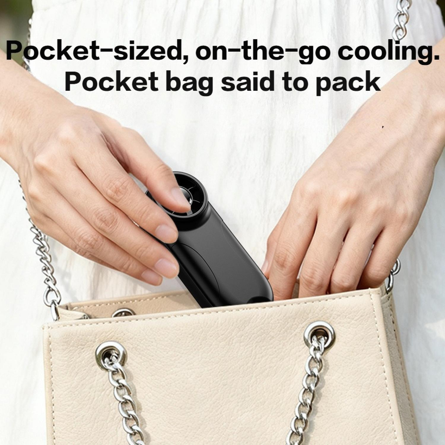 Schwarzer Ventilator wird in eine beige Handtasche gelegt.
