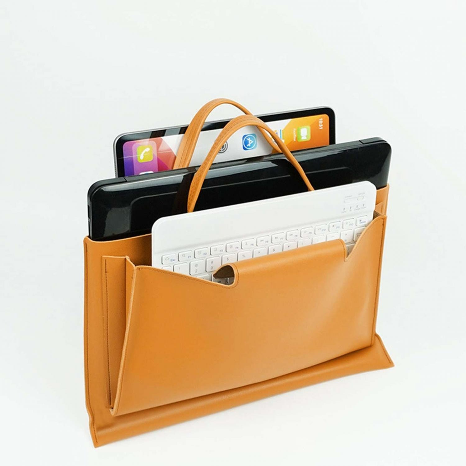 Eine braune Ledertasche mit einem weißen Keyboard und einem Tablet.