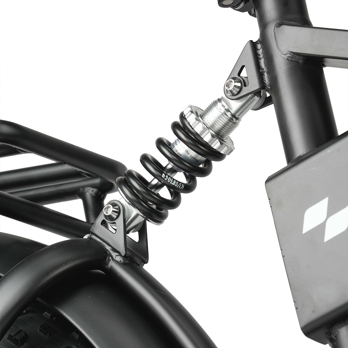 Czarny amortyzator ze srebrnymi akcentami na ramie roweru.