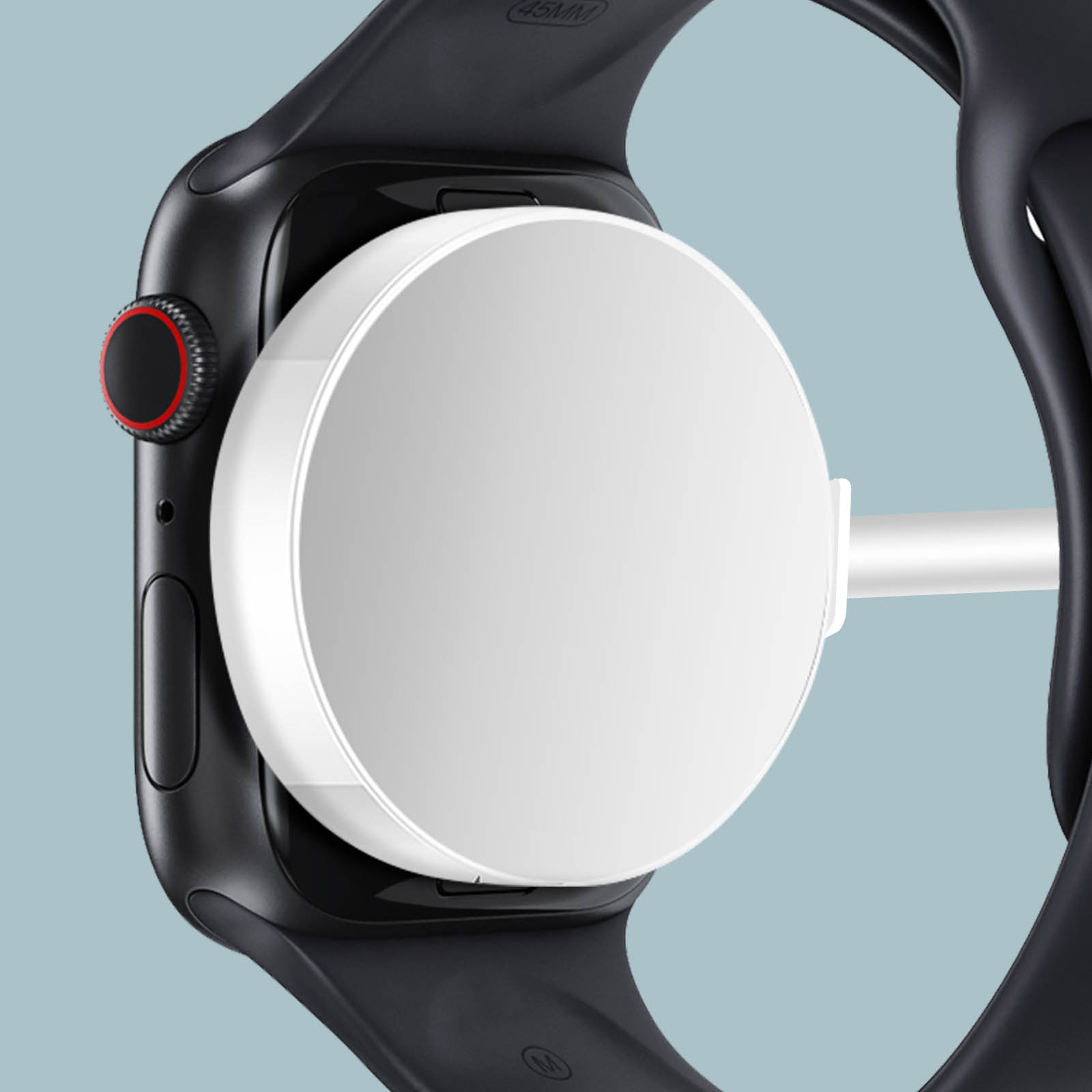 Uno smartwatch nero si sta caricando su un caricabatterie bianco.
