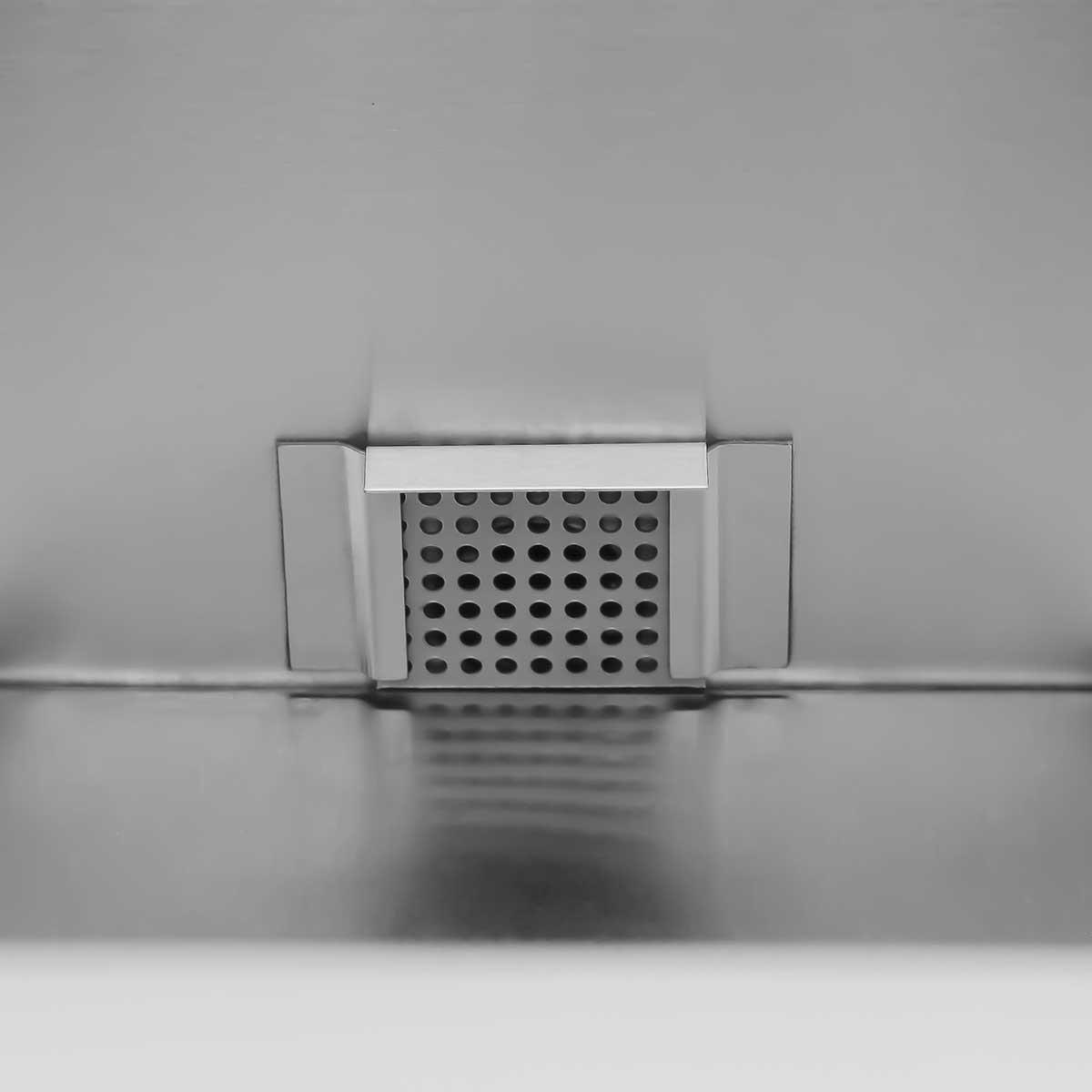 A square metal drain with many small holes in a smooth metal surface.