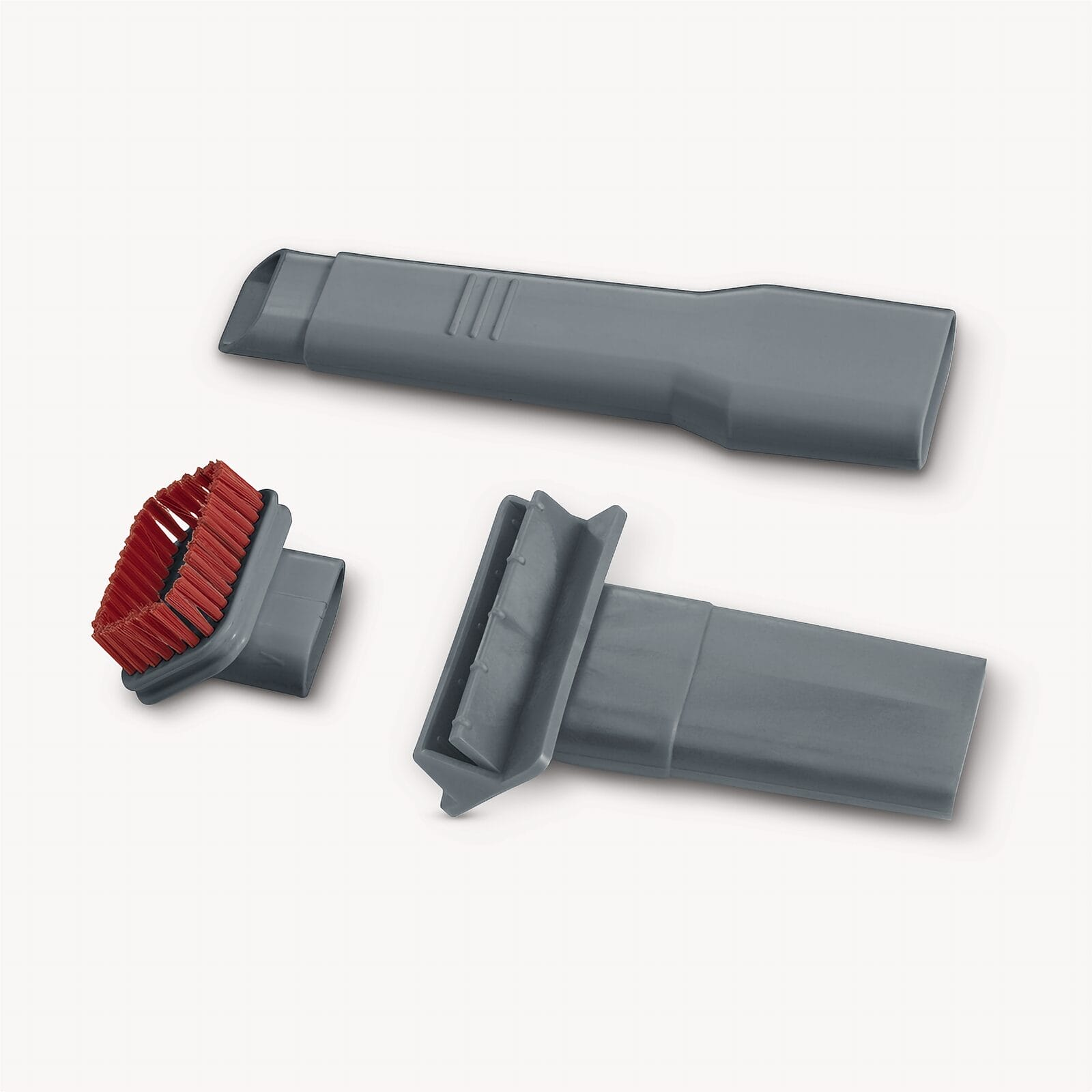 Szare końcówki do odkurzacza: szczotka i dwie dysze na białym tle.