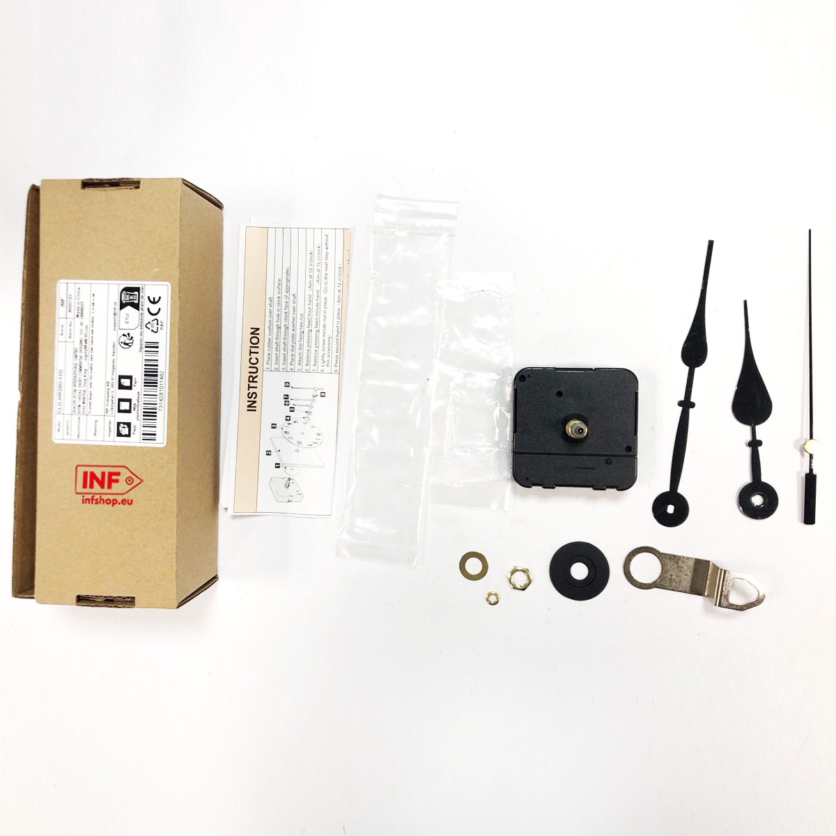 Un kit movimento orologio con istruzioni, lancette e piccole parti su sfondo bianco.
