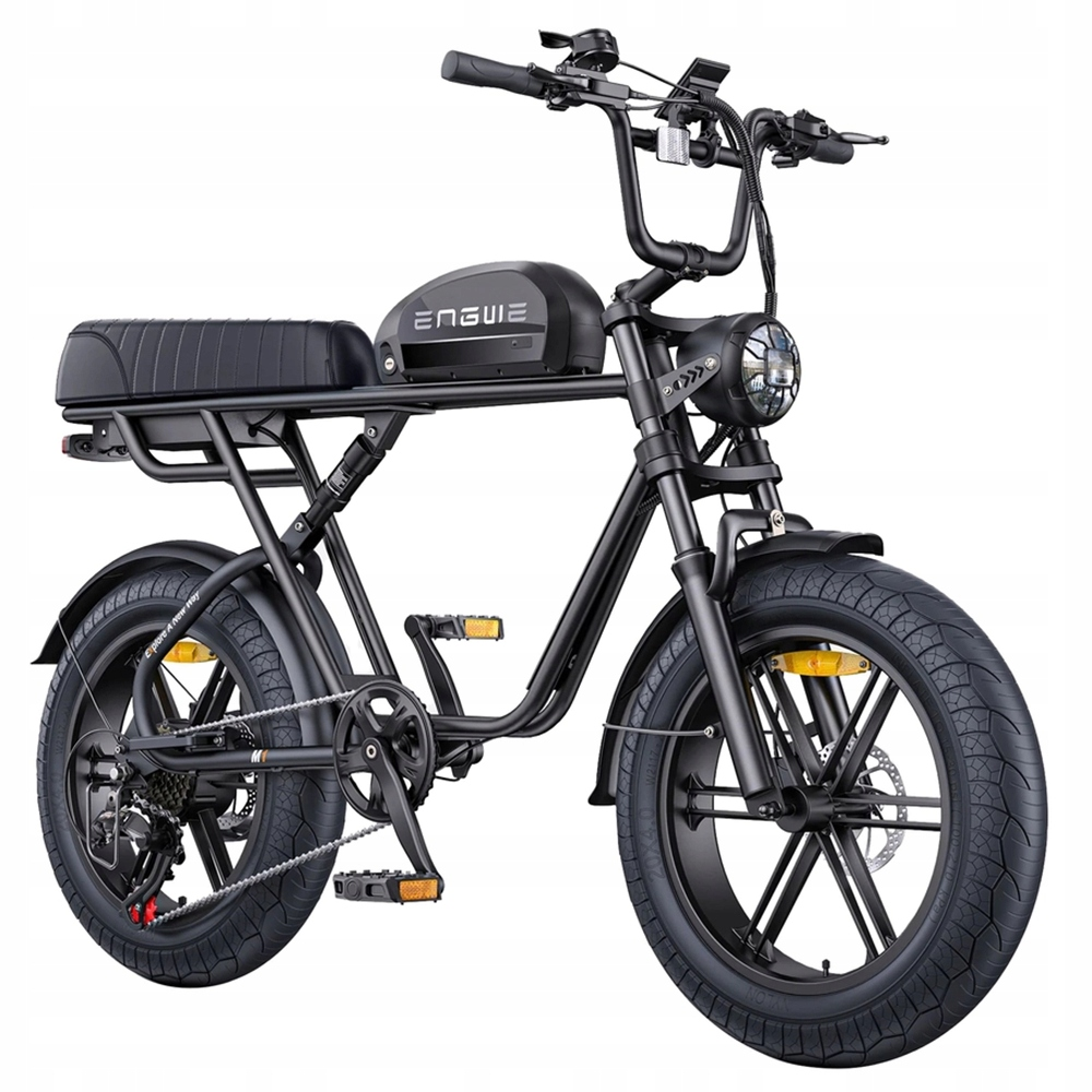 Bicicleta eléctrica negra con neumáticos anchos, sillín con resorte y batería integrada.
