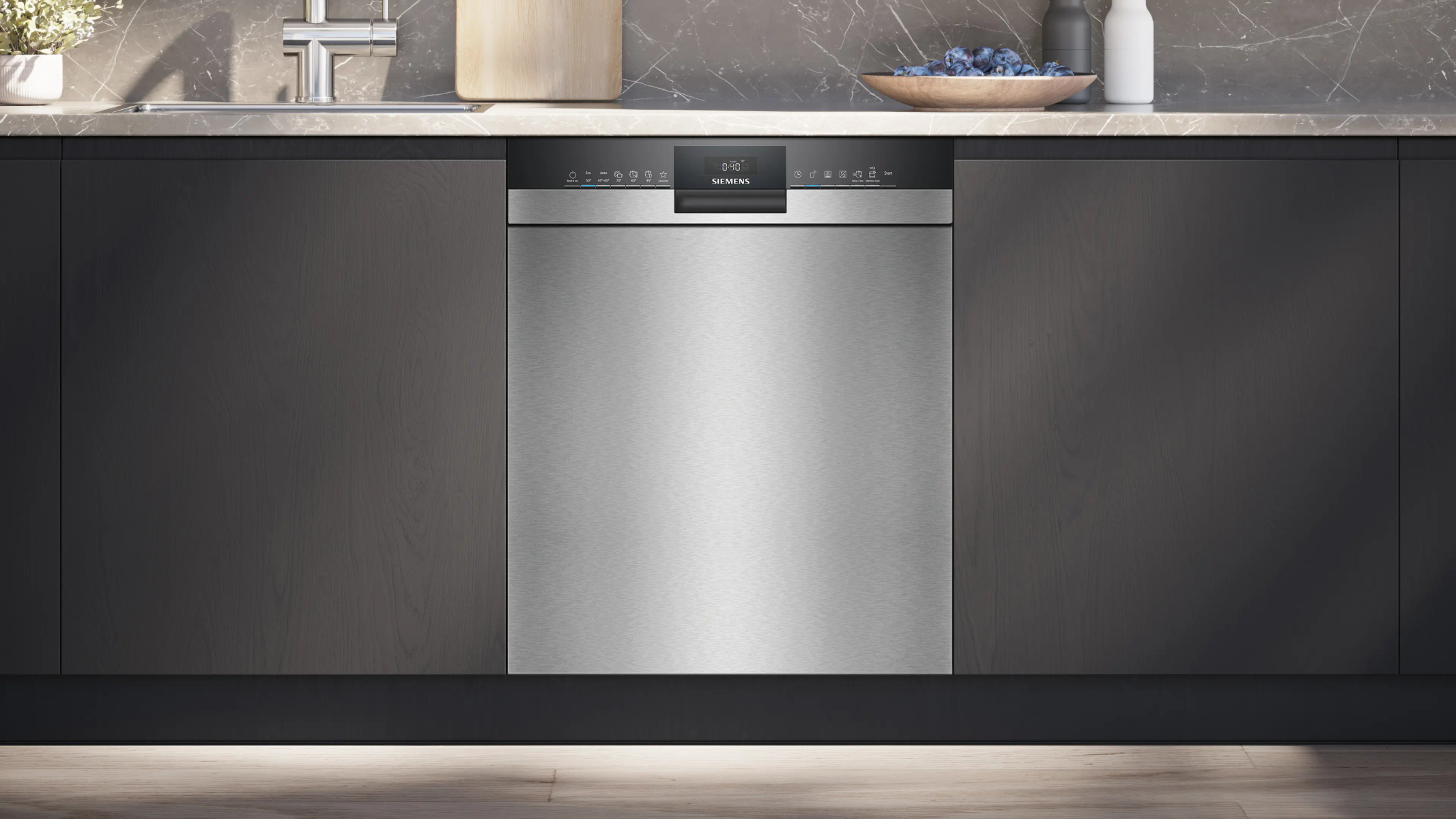 Modern silver dishwasher with black control panel in a kitchen setting.