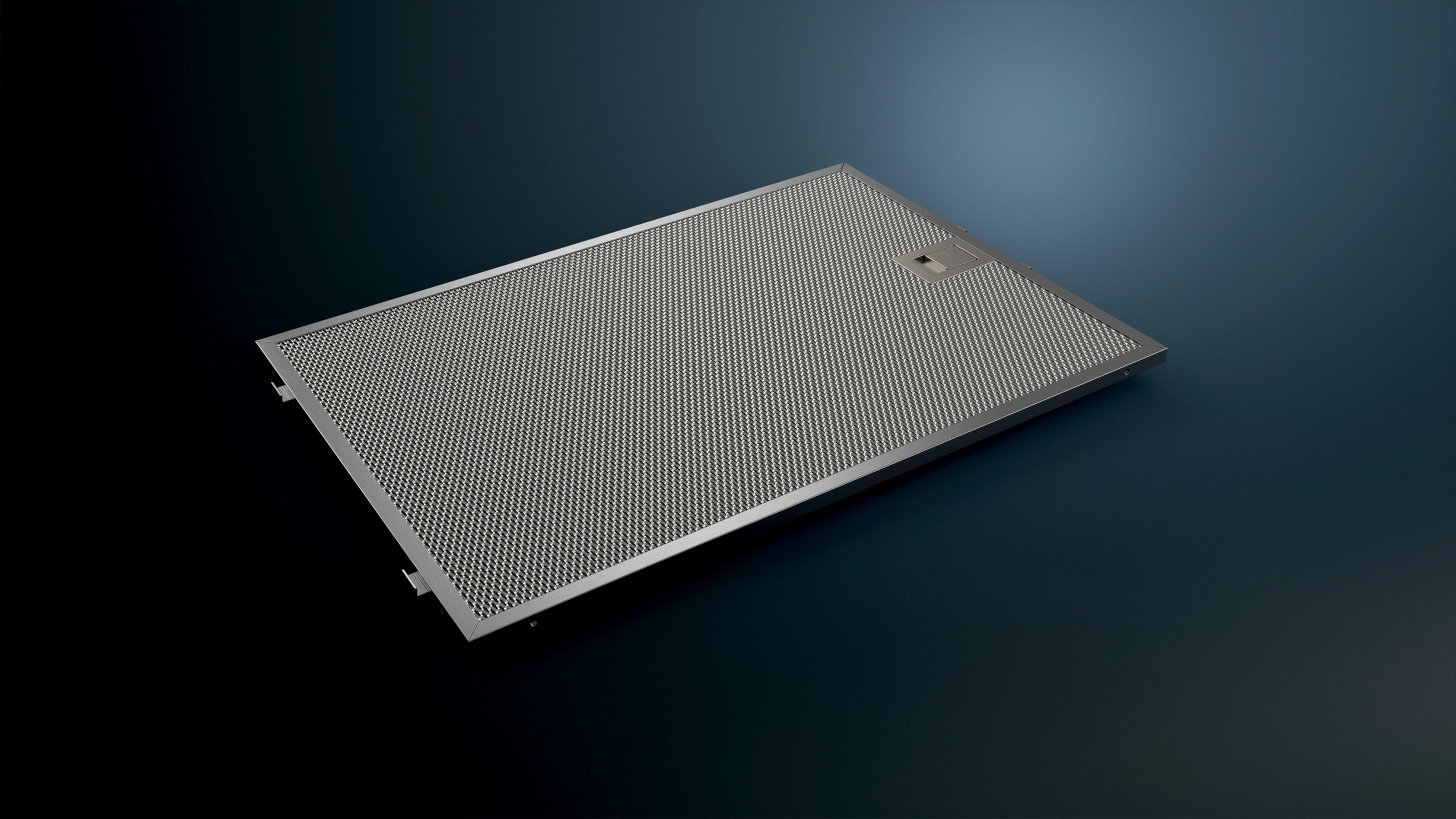 A silver metal filter for a range hood with a fine mesh pattern.