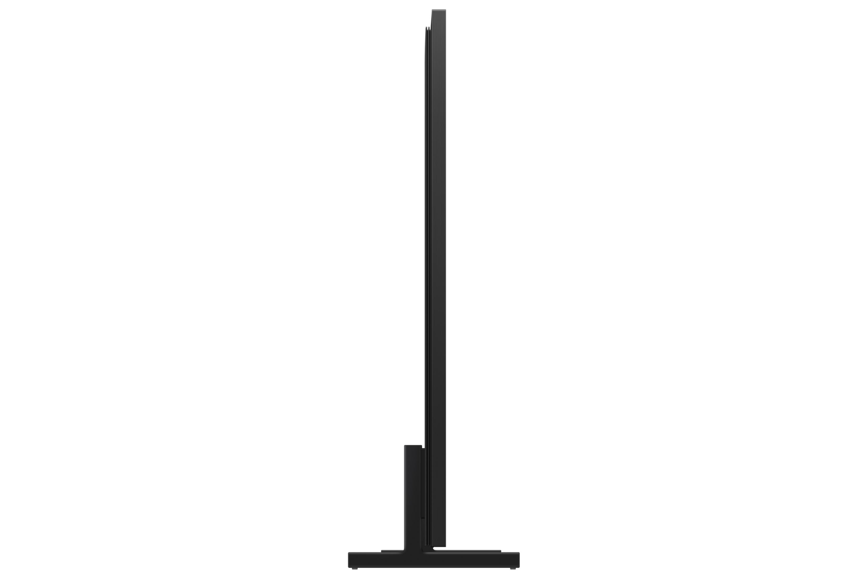 Black television on a stand, seen from the side.