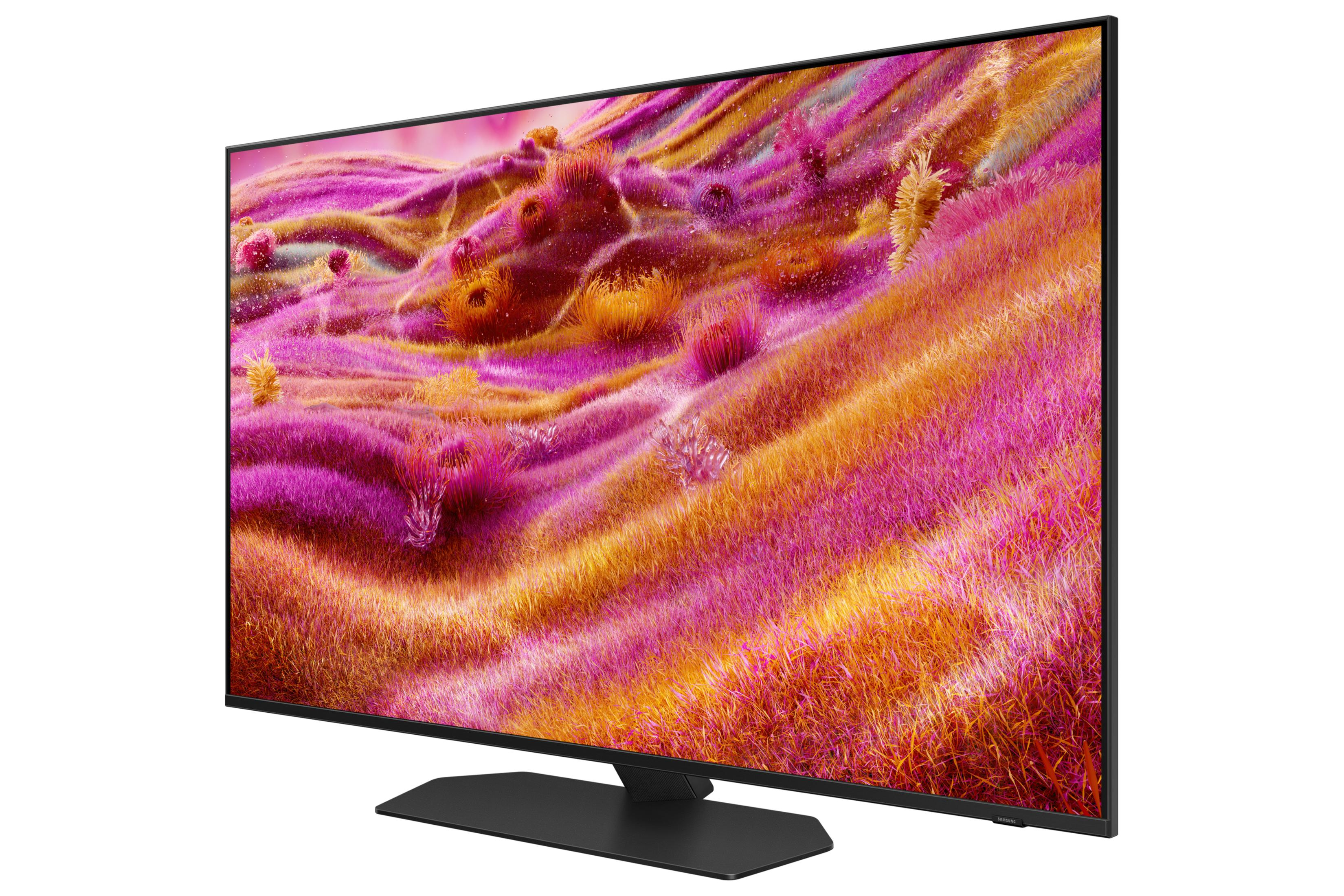 A black television screen displaying a colorful abstract image of pink and orange grass.