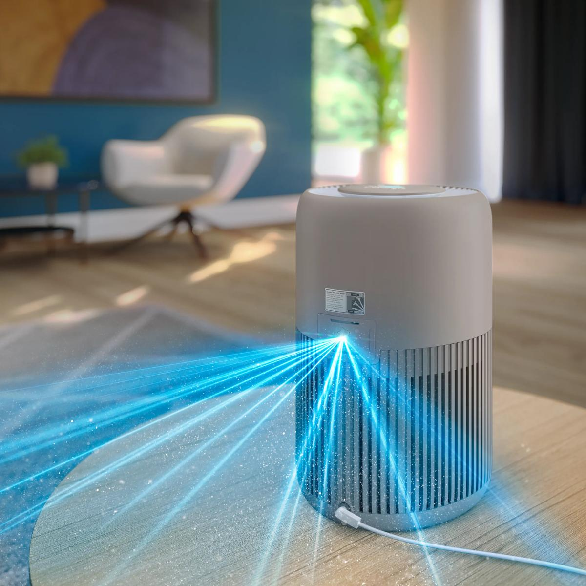 A gray air purifier on a wooden table emitting blue streams of air.
