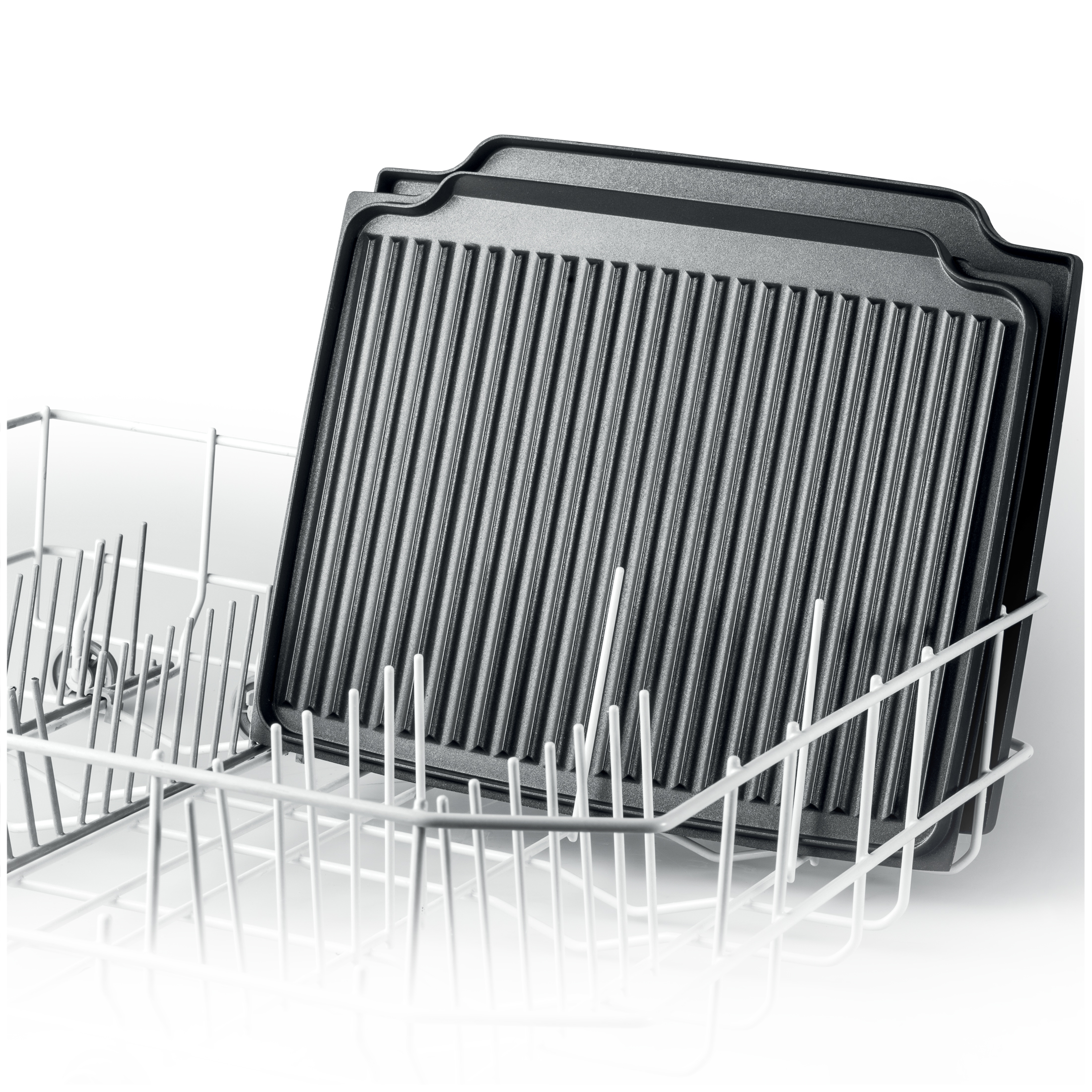Two black metal grill plates inside a white dishwasher basket.