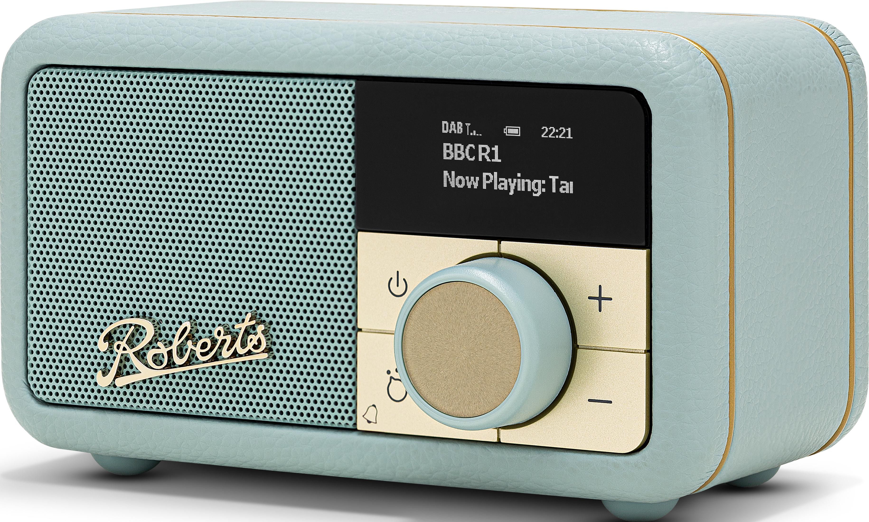 Una radio verde menta con accenti dorati e schermo nero.