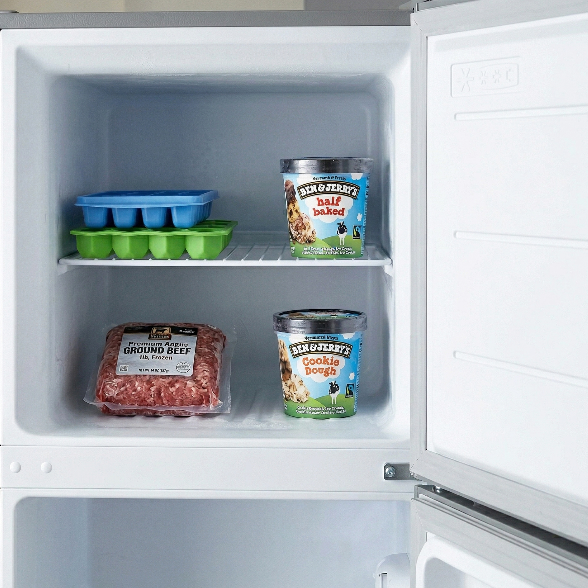 Freezer with ground beef and ice cream tubs.