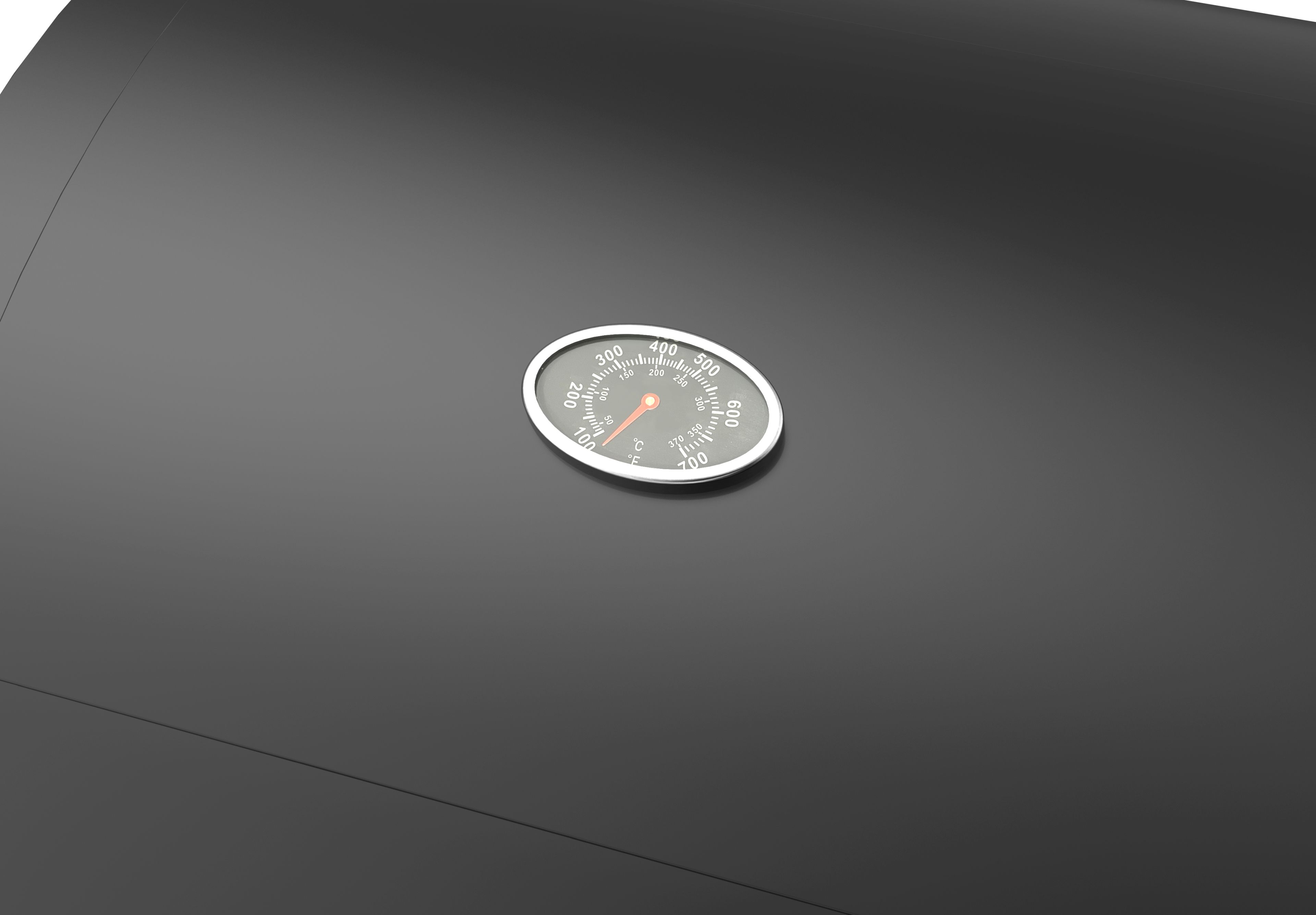 Ein Thermometer auf einem schwarzen Grill mit Skalen in °C und °F.