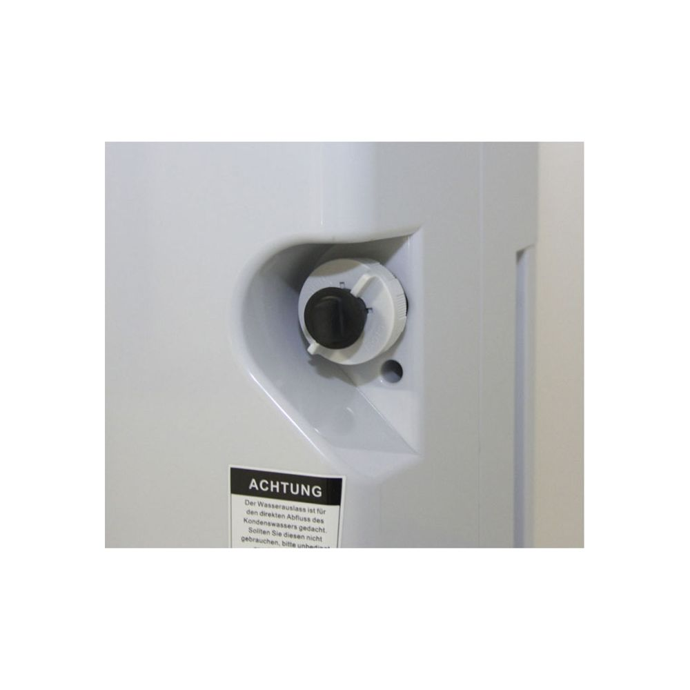 Una manopola nera con anello bianco su un apparecchio bianco. Un'etichetta di avvertenza è attaccata.