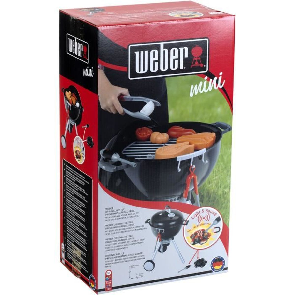 Verpackung eines Weber Mini Holzkohlegrills mit Spielzeug-Lebensmitteln und Lichtern.