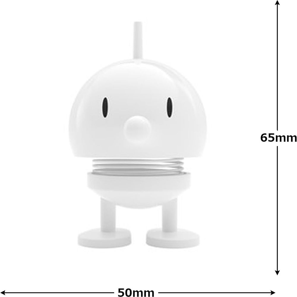 Un oggetto bianco e cartone animato con occhi e bocca. Dimensioni 65x50mm.