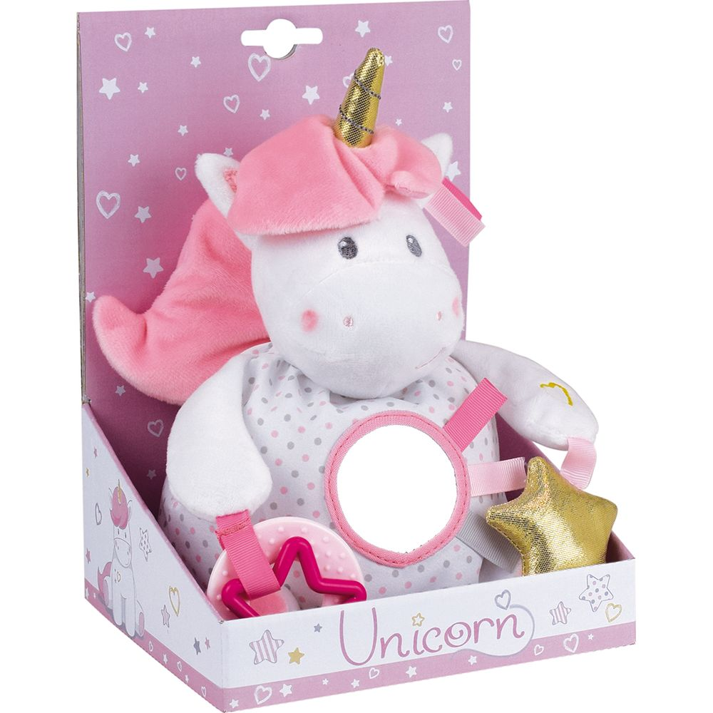 Une licorne en peluche blanche avec une crinière rose et une corne dorée dans une boîte.