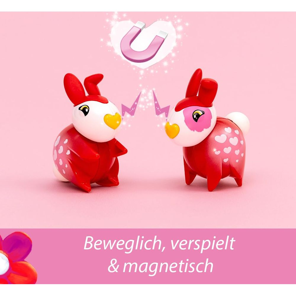 Deux lapins jouets rouges avec des cœurs et un symbole aimanté.