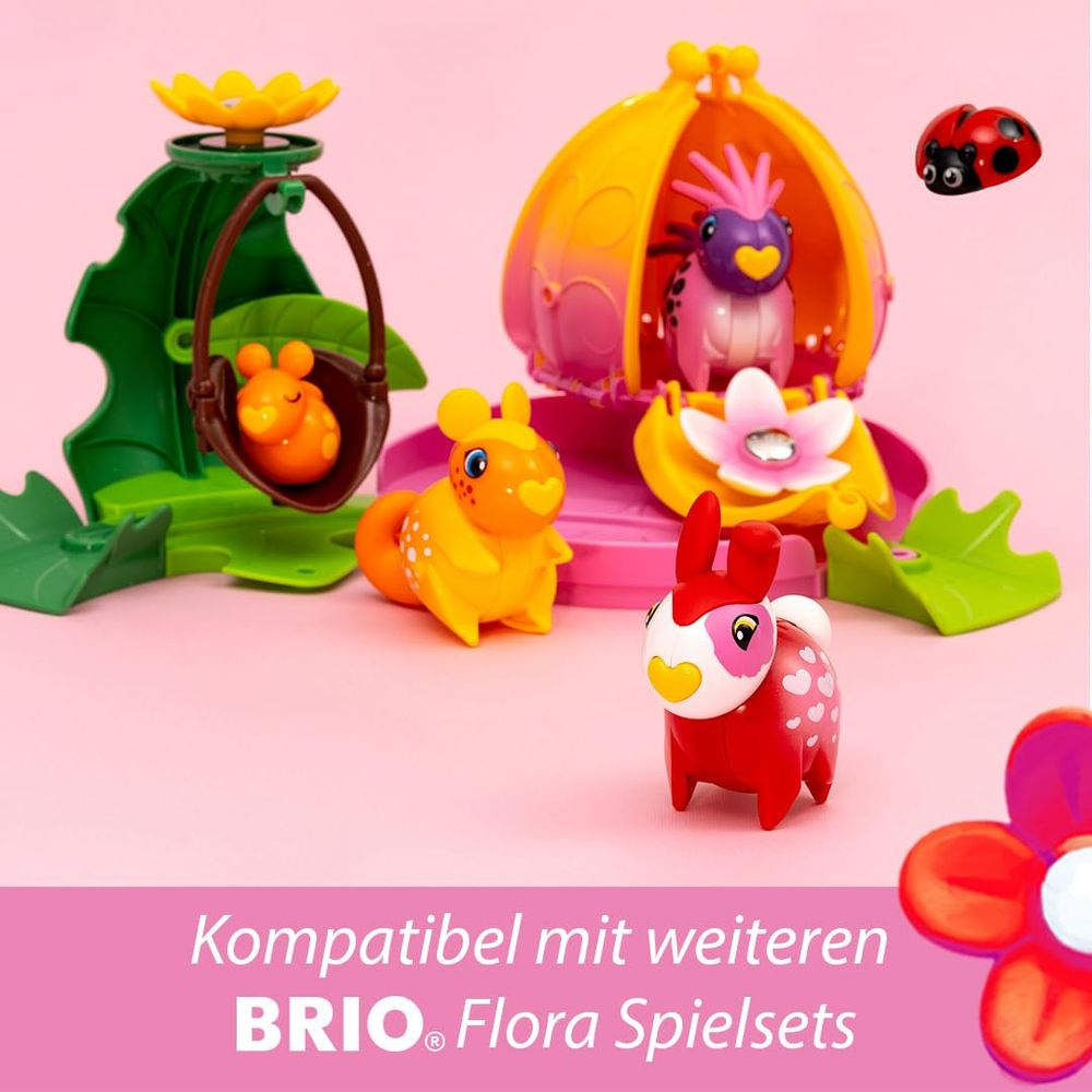 Animaux jouets et plantes colorés sur fond rose. Jeux BRIO Flora.
