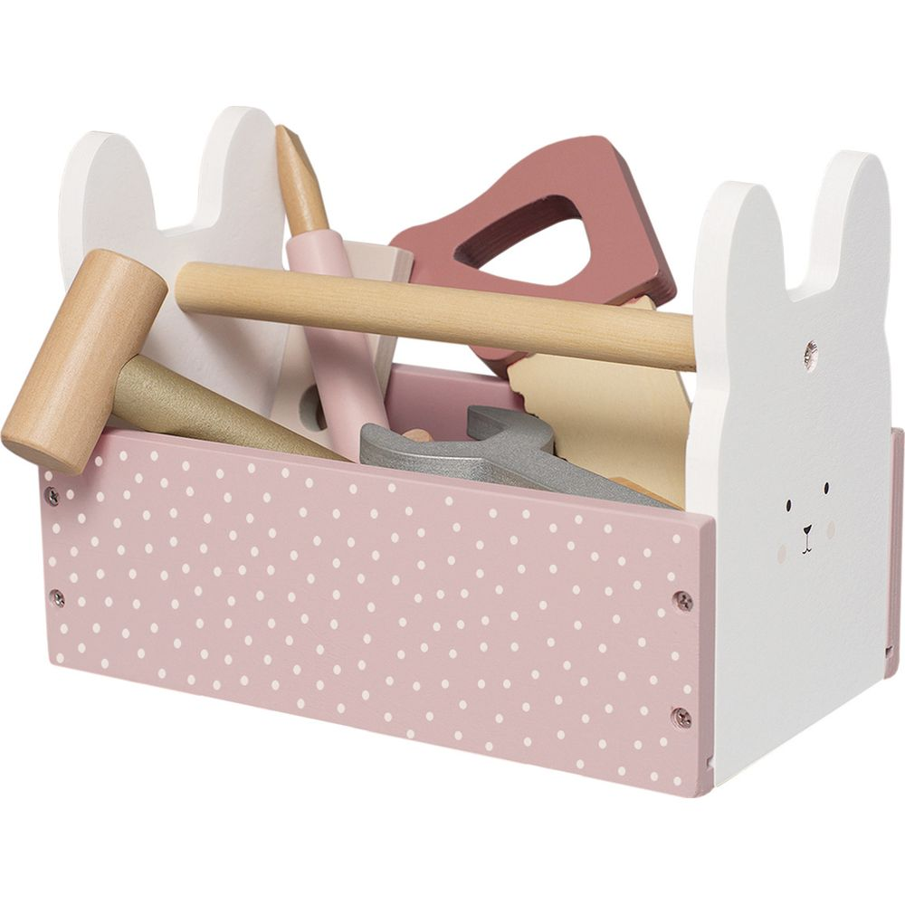 Eine rosa gepunktete Werkzeugkiste mit hölzernem Spielzeugwerkzeug, mit Hasenohren.