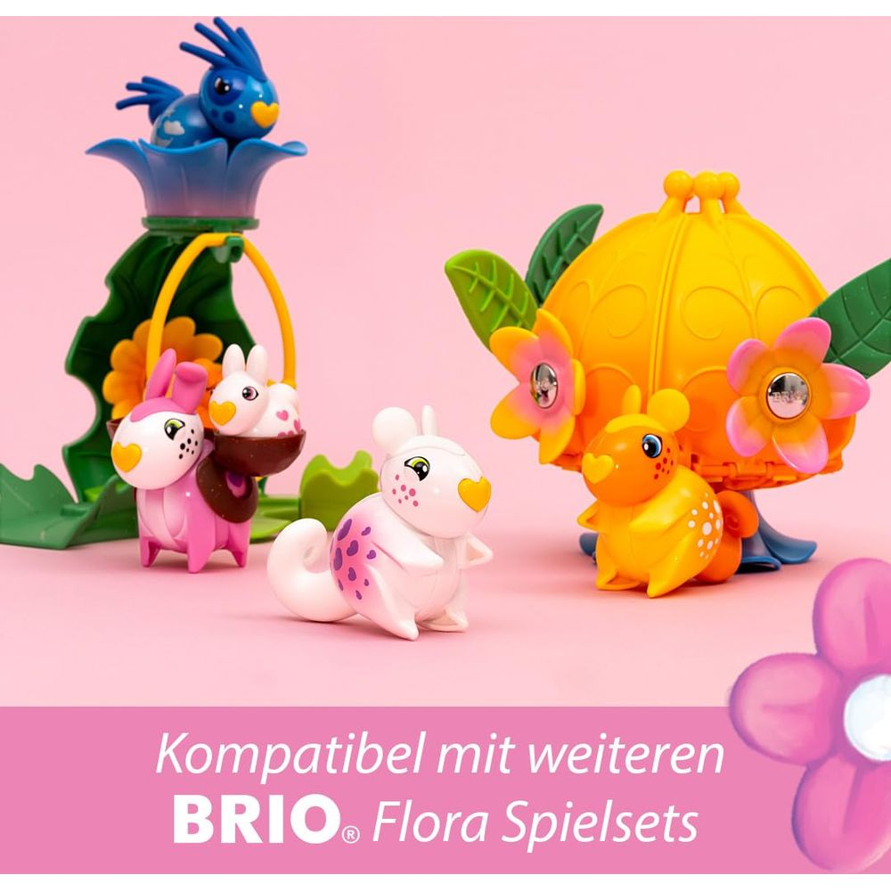 Animaux jouets BRIO Flora colorés : lapin, oiseau et écureuil sur fond rose.