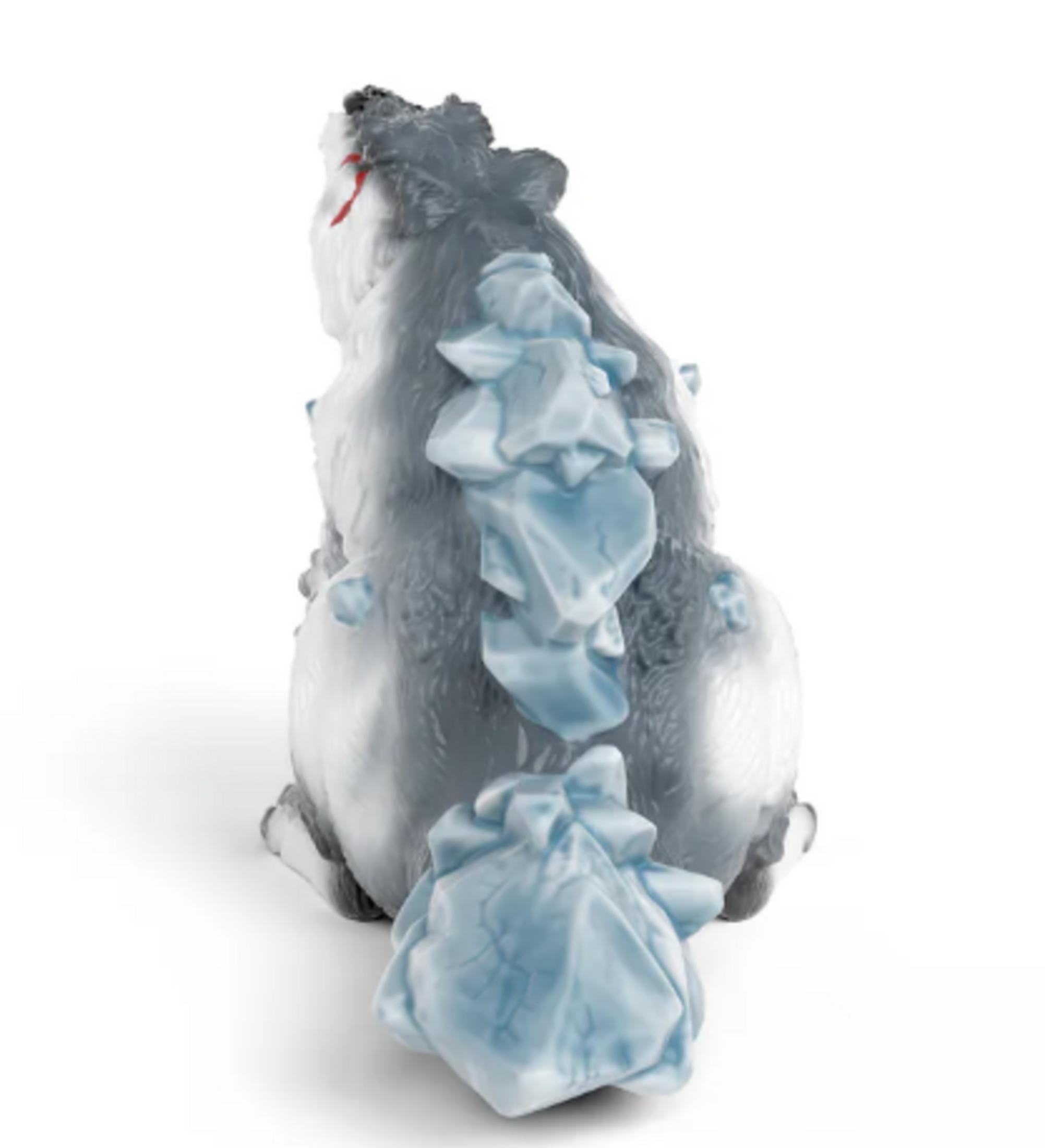 Figurine de loup grise avec des morceaux de glace dépassant de son dos et de sa queue.