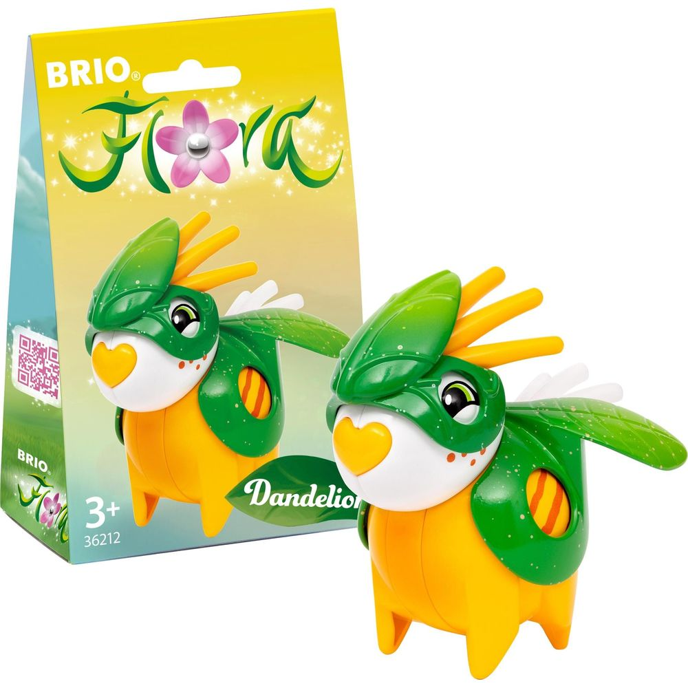 Ein gelber und grüner Spielzeugdinosaurier mit orangem Schnabel vor einer Packung.