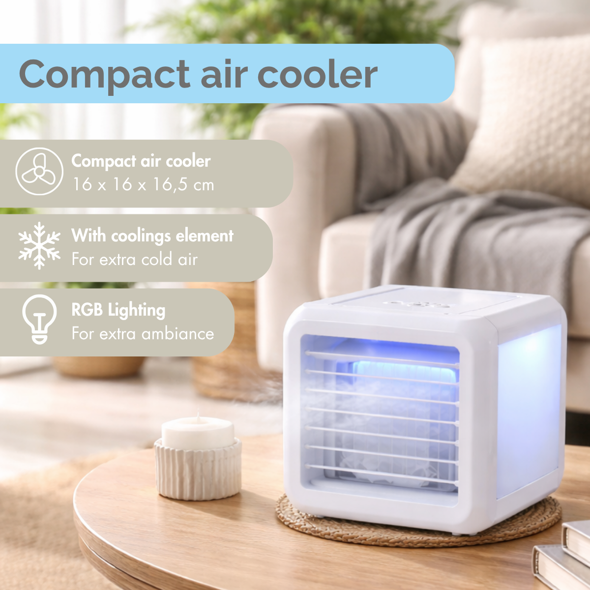 White compact air cooler with blue light and mist on a table with a candle.