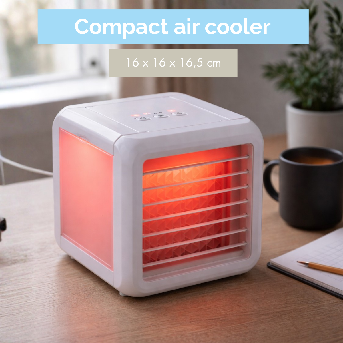 A white compact air cooler with red light on a wooden desk.
