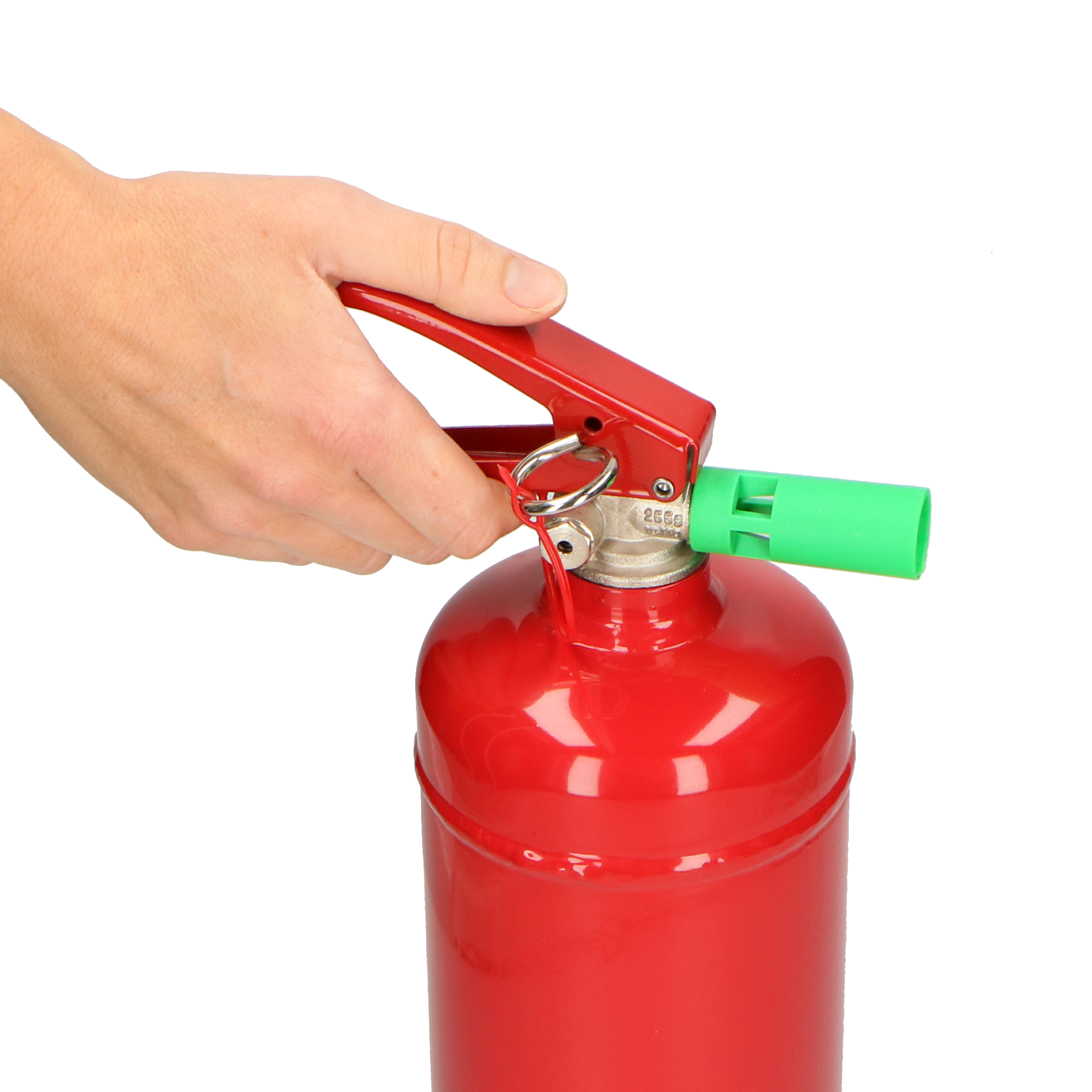 A hand holds the red handle of a fire extinguisher with a green nozzle.