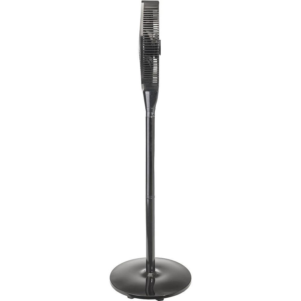 A black standing fan with a round base and a narrow grille.
