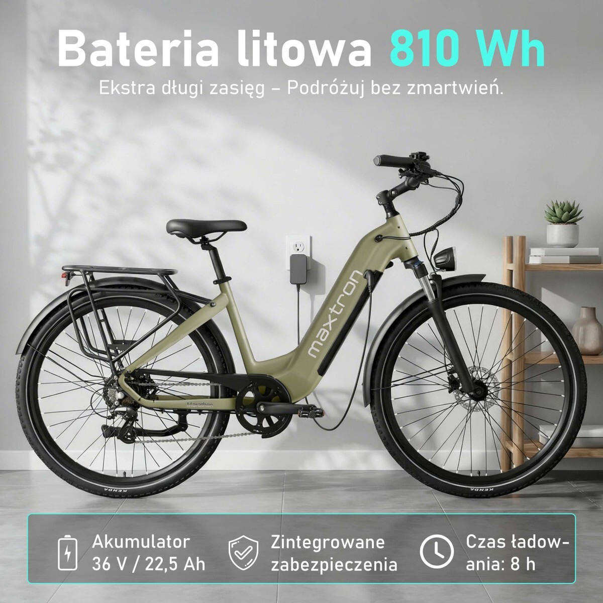 Oliwkowozielony rower elektryczny podłączony do gniazdka, wewnątrz.