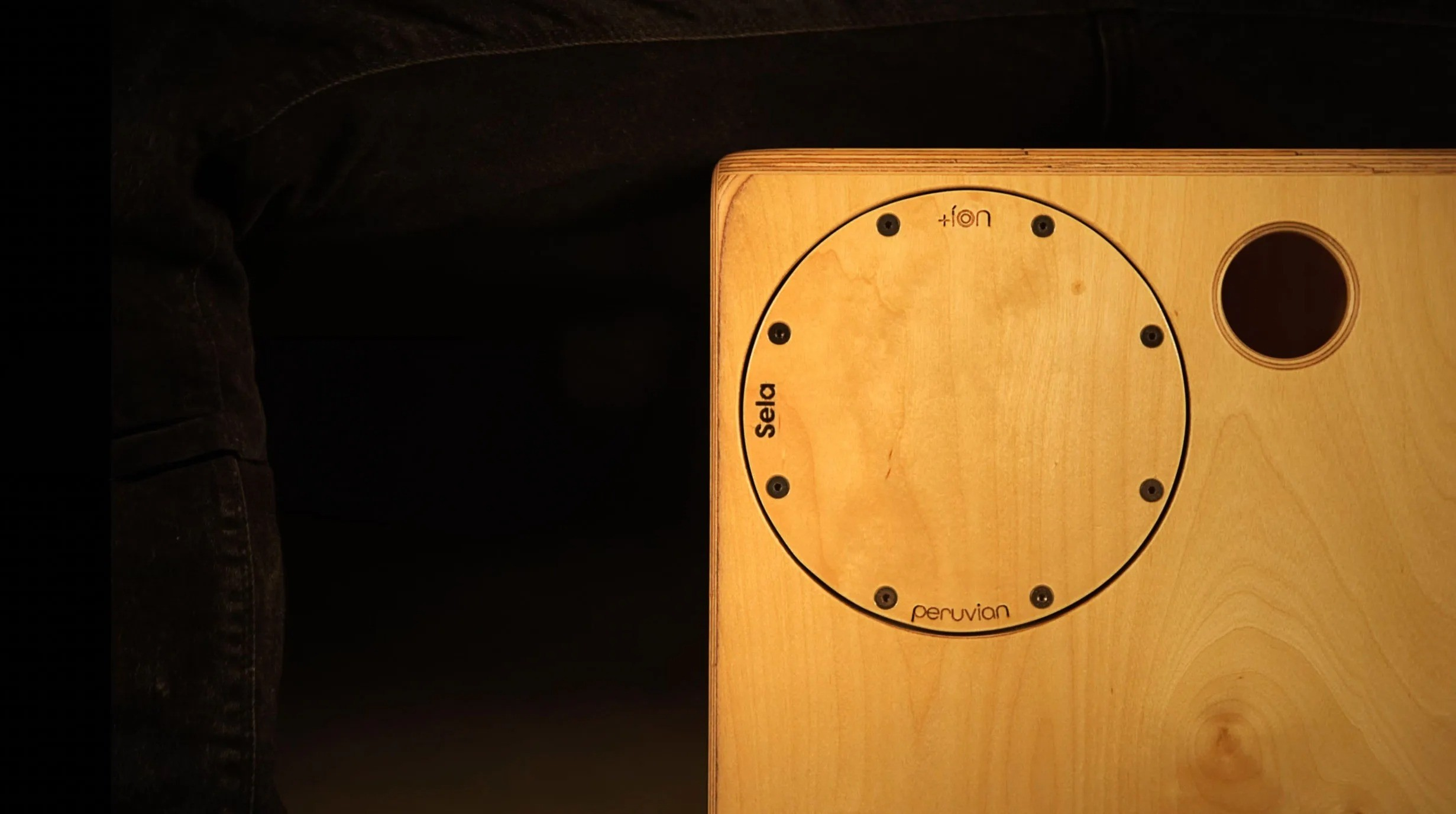 Ses deli ve yuvarlak girintili ahşap bir cajon.