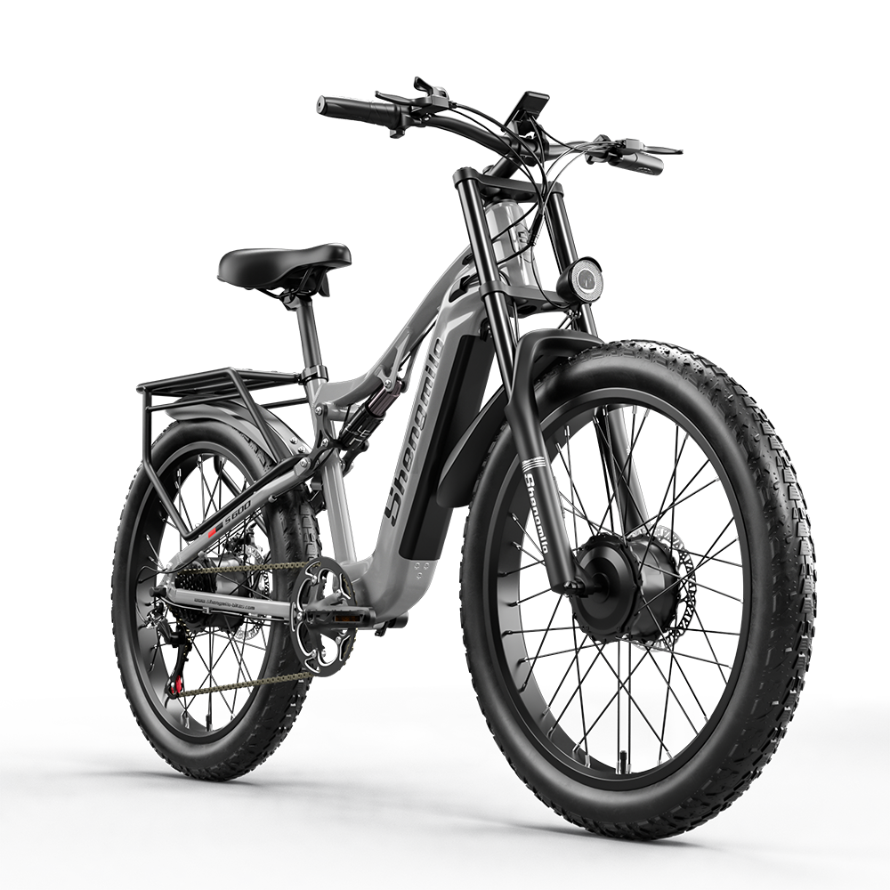 Graues E-Bike mit dicken Reifen, Federung und Gepäckträger.