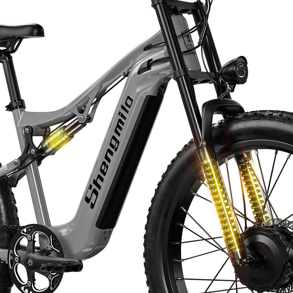 Graues Shengmilo E-Bike mit gelben Stoßdämpfern und fetten Reifen.