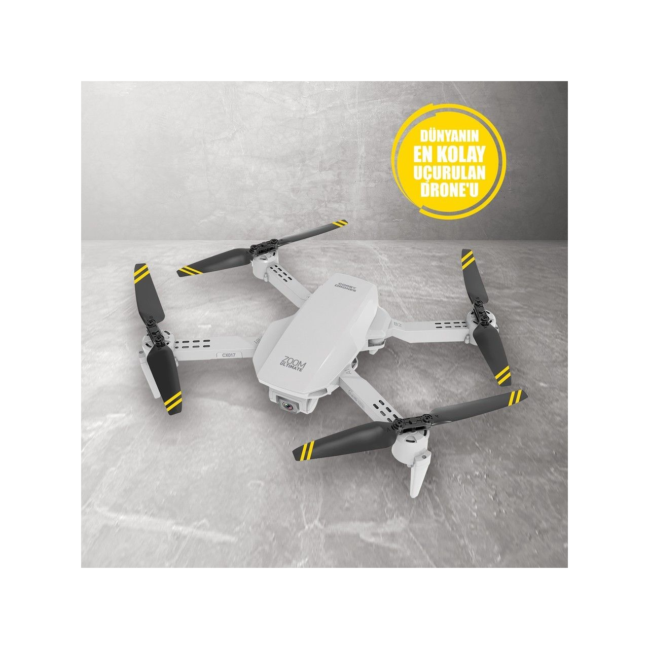 Sarı şeritli siyah pervaneli beyaz katlanabilir drone beton zemin üzerinde duruyor.