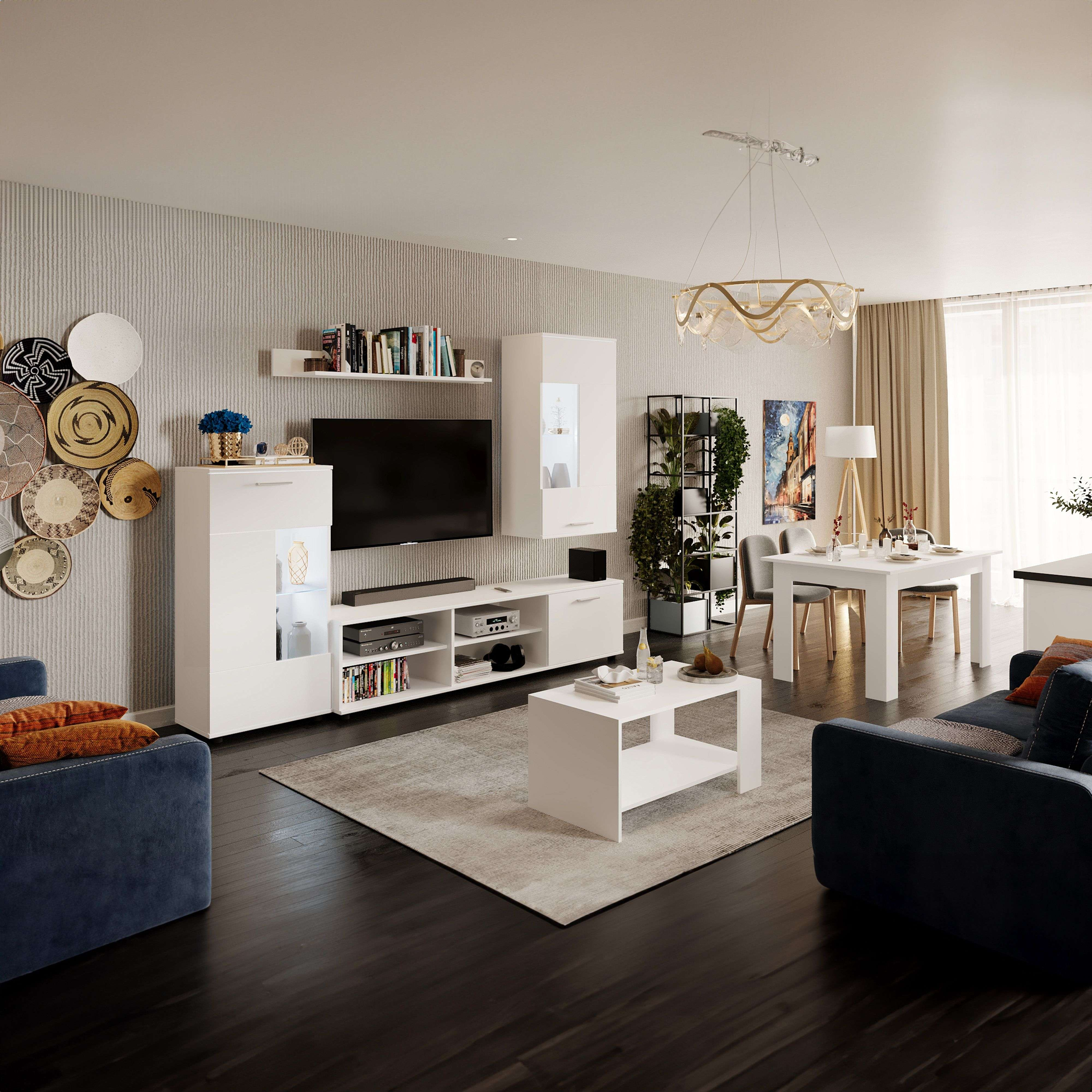 Una sala de estar moderna con comedor, sofá azul, mesa blanca y plantas.