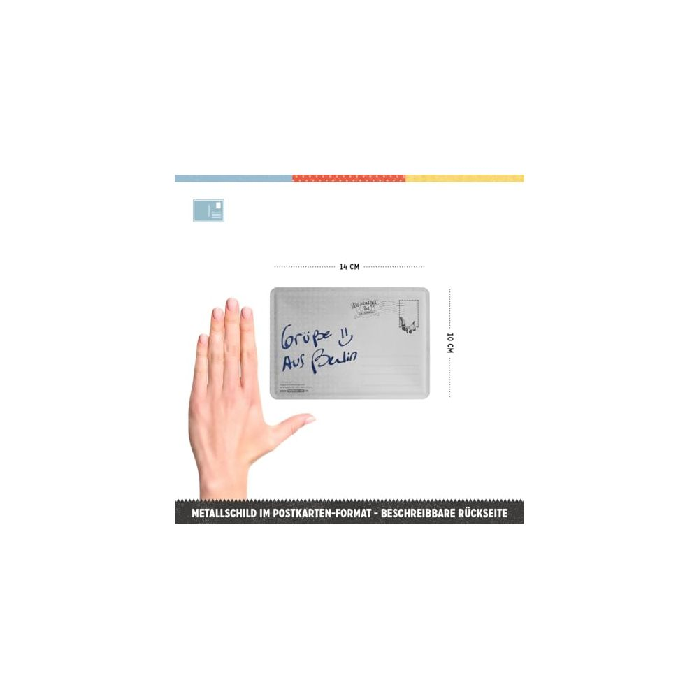 Eine Hand hält ein metallisches Postkartenformat-Schild mit Aufschrift.