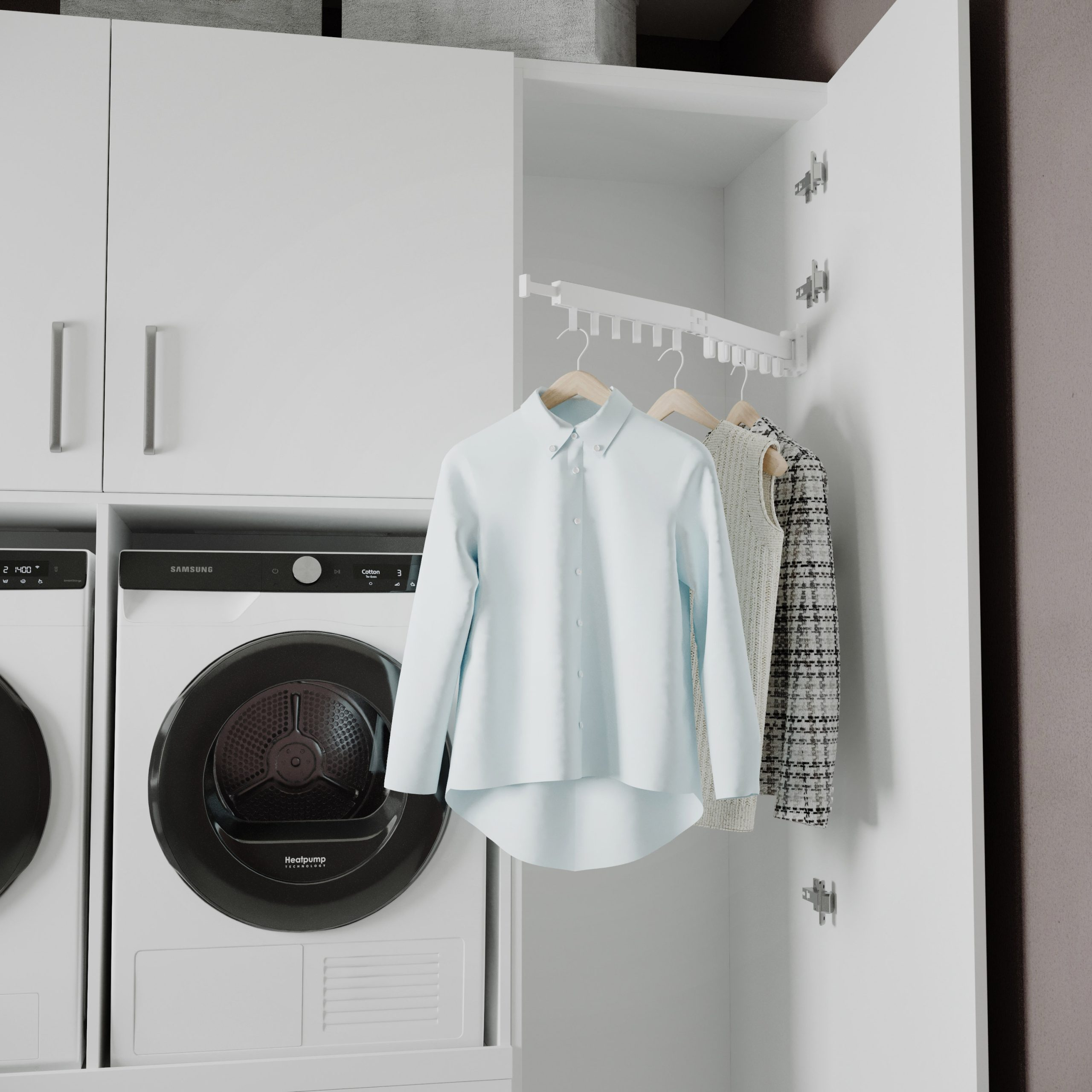 Machine à laver et sèche-linge blancs avec des vêtements suspendus à un étendoir rétractable.