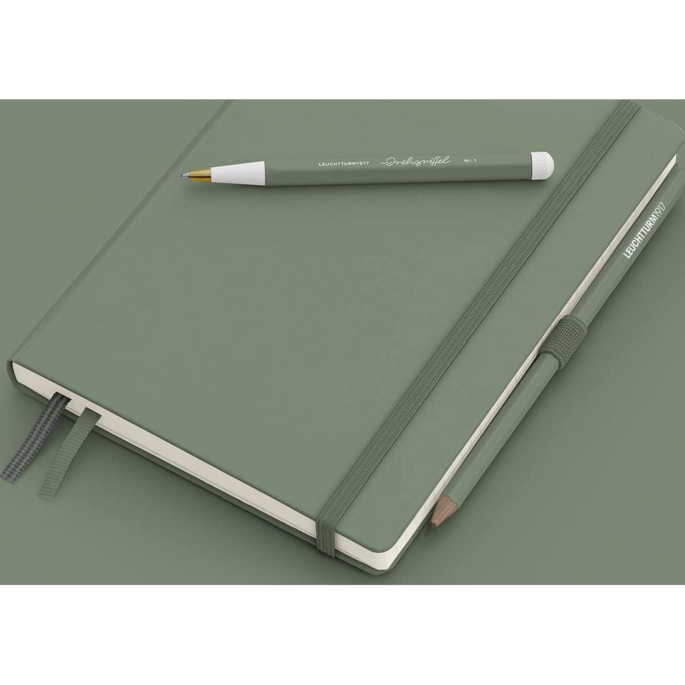 Ein grünes Notizbuch mit grünem Stift und Bleistift. Zwei Bänder markieren Seiten.