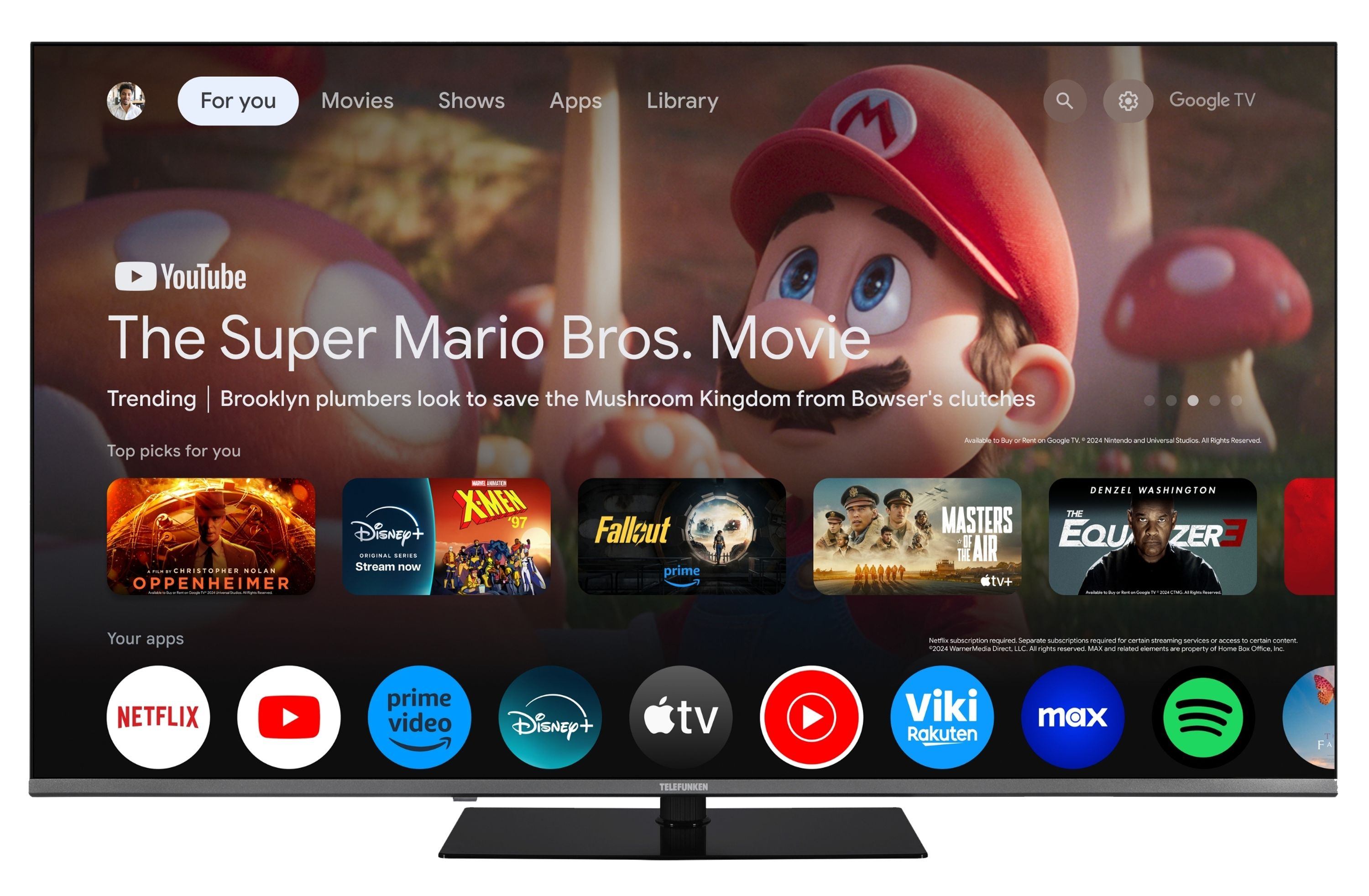 Startbildschirm von Google TV mit Mario, Filmtrailern und App-Symbolen.