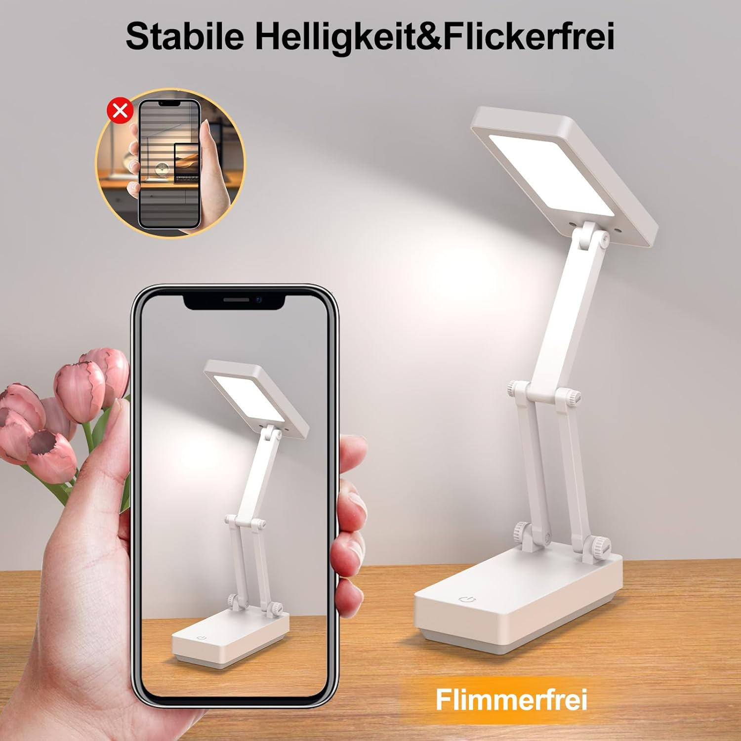 Eine weiße, faltbare Schreibtischlampe mit LED-Licht auf einem Holztisch.