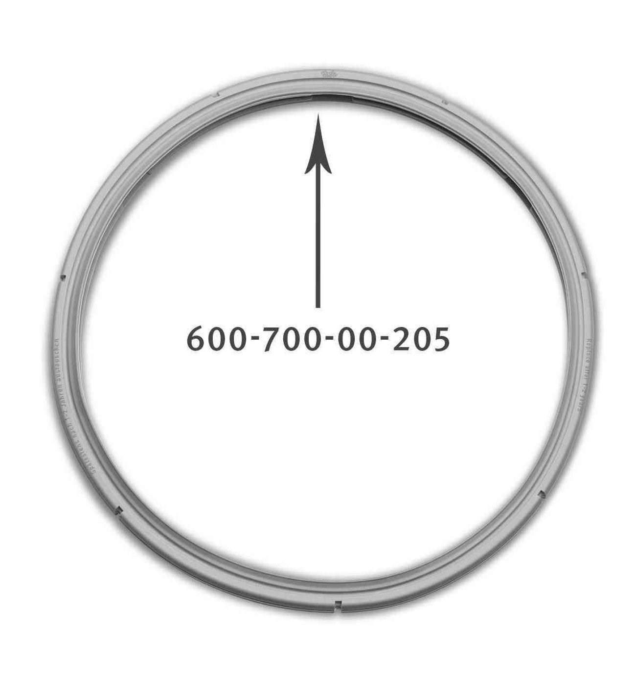 Junta gris con texto 600-700-00-205 y una flecha apuntando hacia arriba.