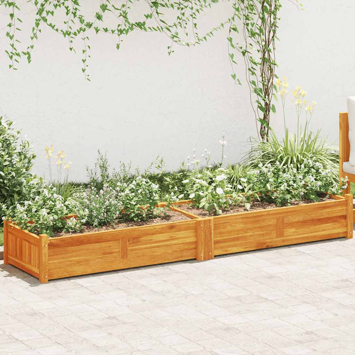 Holzhochbeet mit Grönflächen und Blumen vor einer Weißwand.