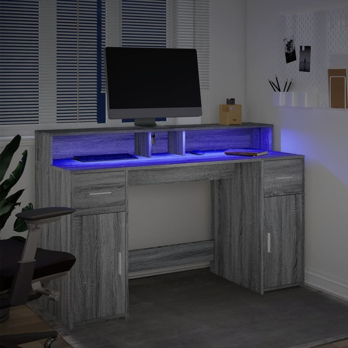Grauer Schreibtisch mit blauem LED-Licht, Monitor, Tastatur und einem Stuhl.