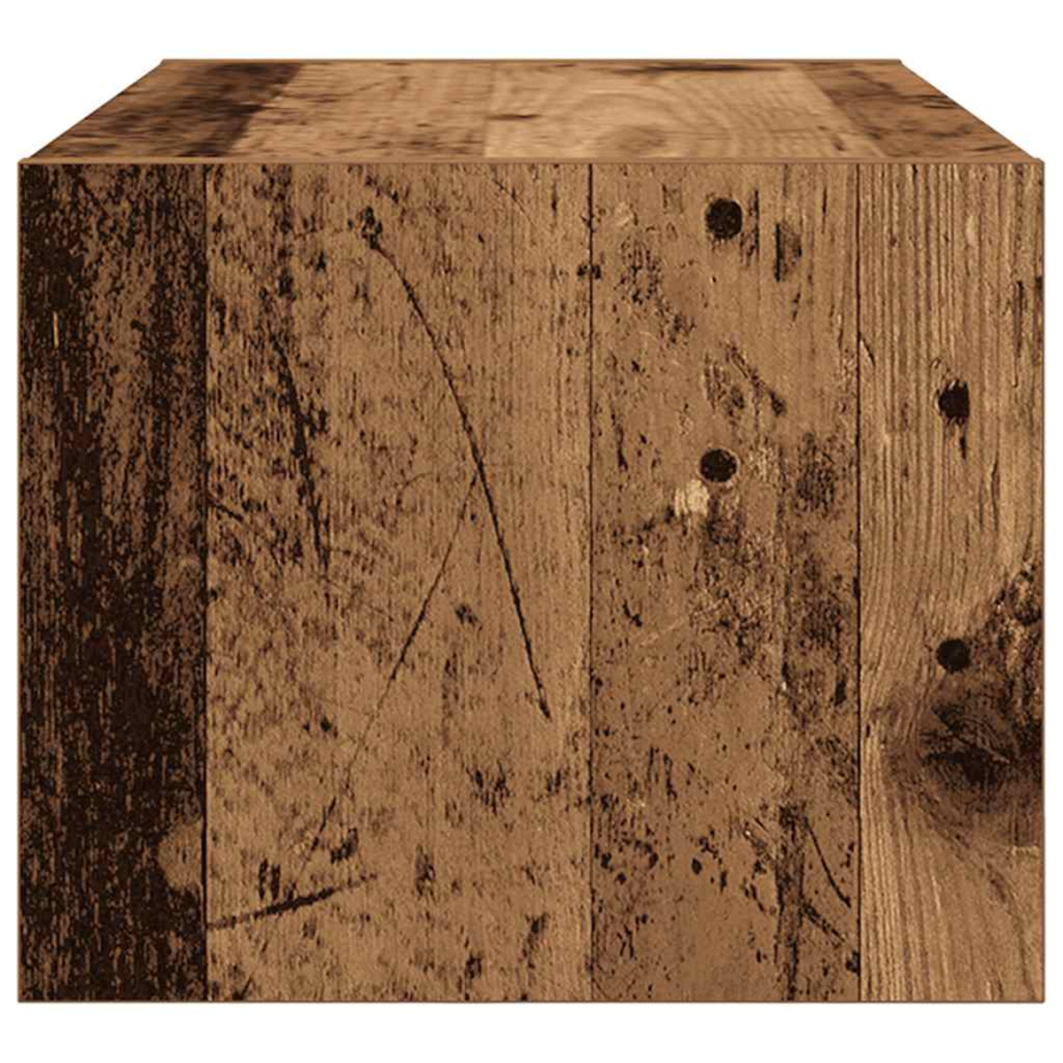 Un primer plano de un cubo de madera con textura de tablones desgastados y nudos visibles.