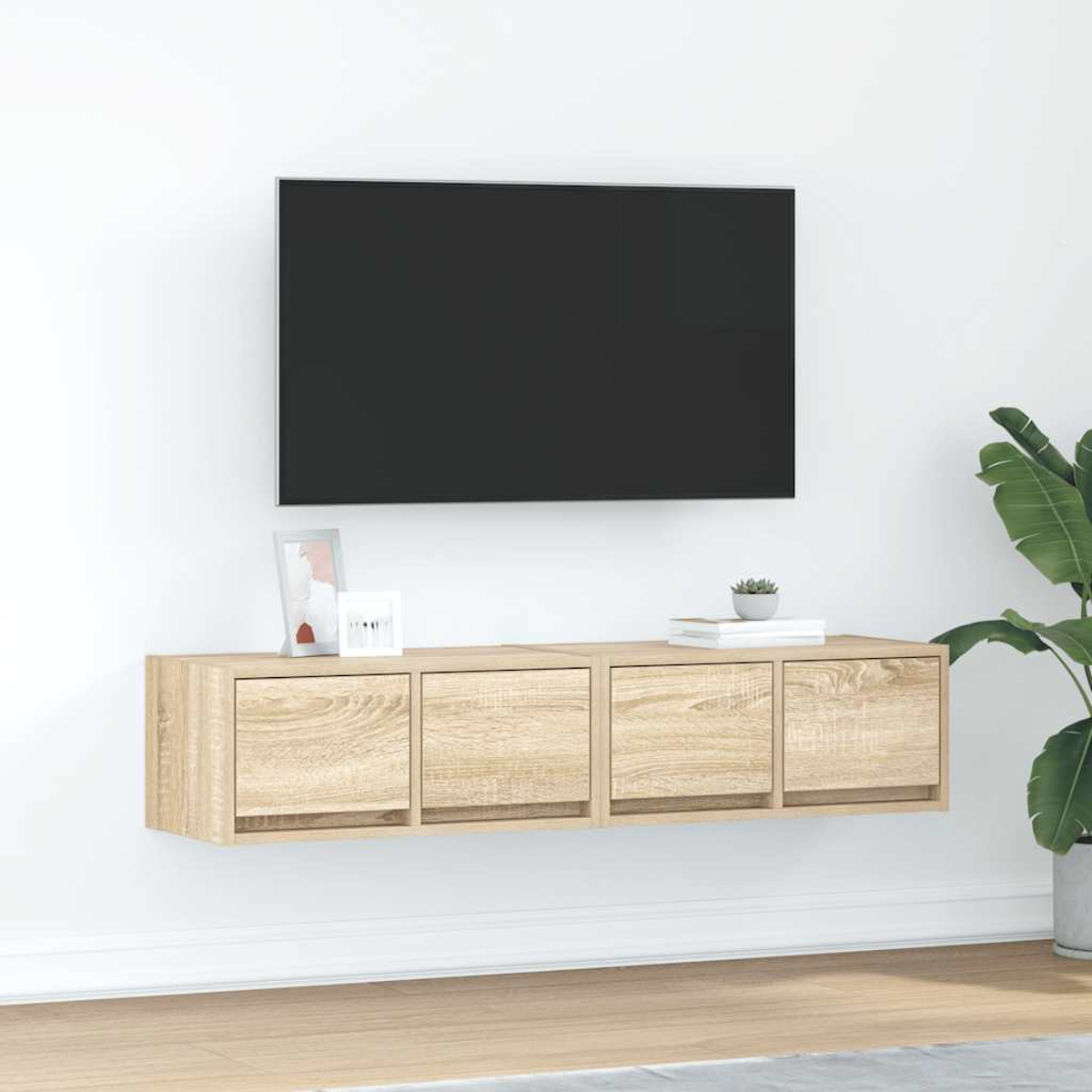 Eine schwebende Holzkonsole mit vier Schubladen unter einem schwarzen Fernseher.