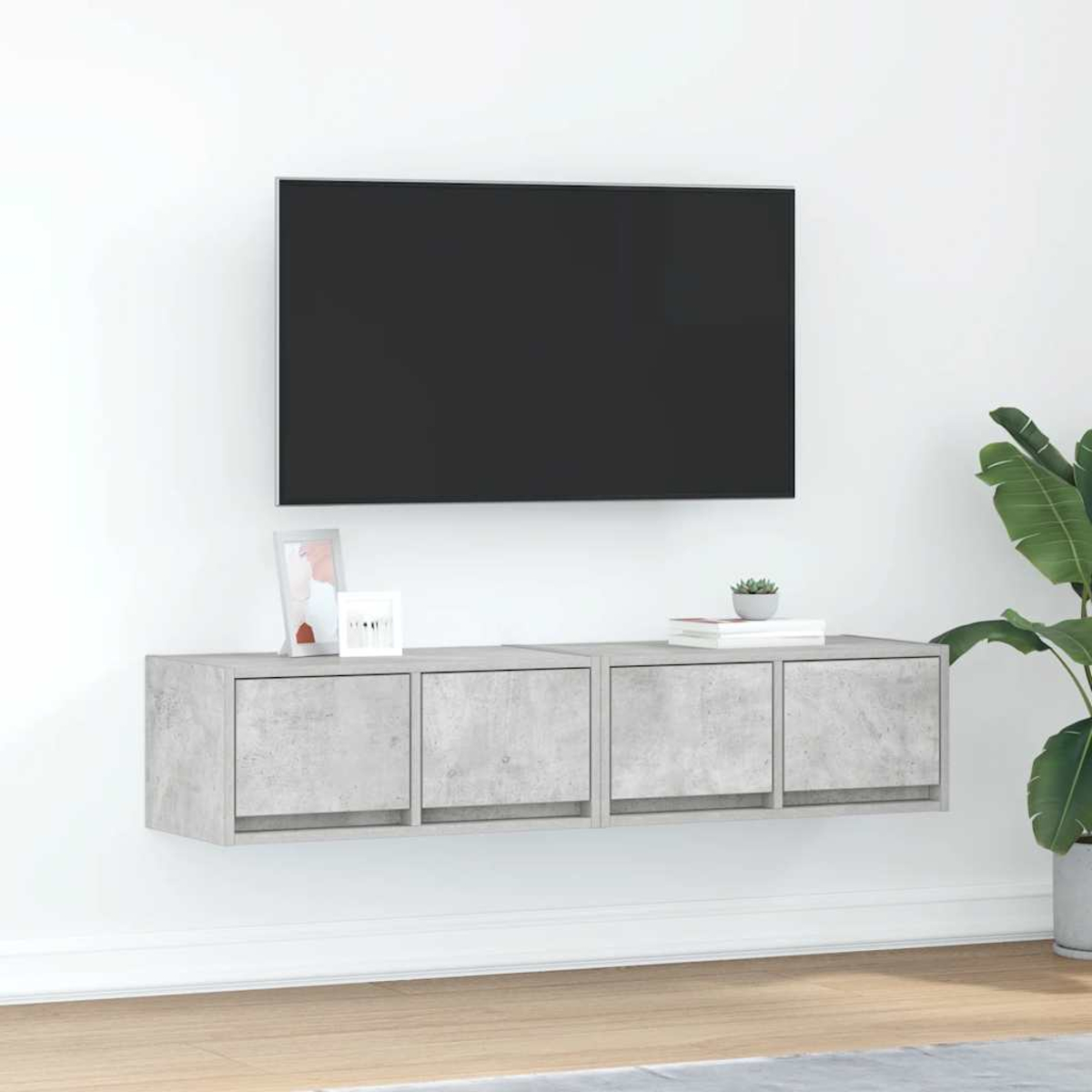 Eine Wandhalterung mit vier Fächern unter einem Fernseher.