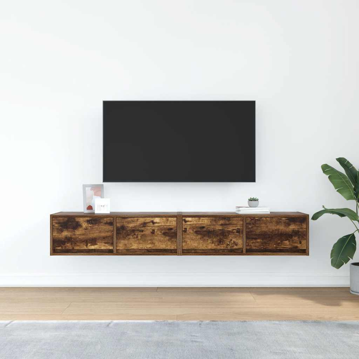 Ein schwebender Holz-TV-Schrank mit vier Schubladen unter einem schwarzen Fernseher.